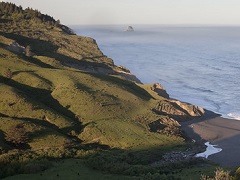 Gentle green hill roll into the Pacific Ocean. Photo by Bob Wick, BLM.