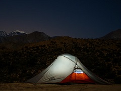 An illuminated tent at night in the mountain. Photo by Dan Maus/BLM.