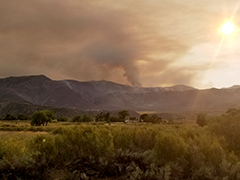 Smoke rising over a mountain from the Slink Fire.