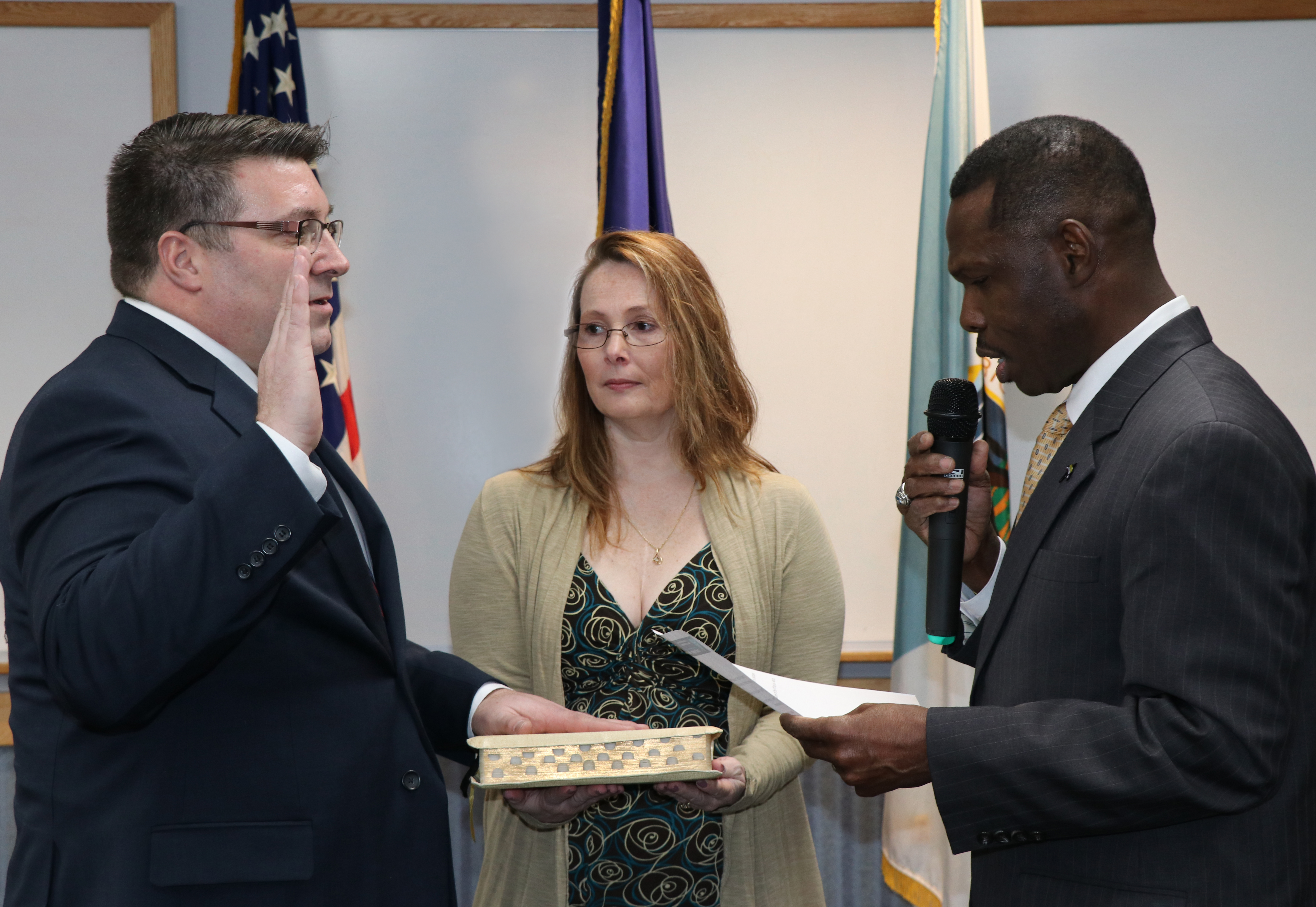 BLM Deputy Director of Operations Mike Nedd (right) administers the oath of office to new BLM Alaska State Director Chad Padgett (left) with the help Padgett’s wife Kambe to a crowd of about 200 family, friends, colleagues, and agency employees yesterday at the Federal Building in downtown Anchorage.