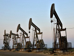 Image of four oil derricks in a row. Photo by John Ciccarelli, BLM.