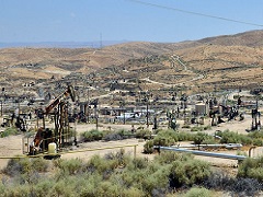 Image of a field of oil derricks. Photo by John Ciccarelli/BLM