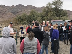 A group of council members stand at a corral in the desert. Photo by Sarah K. Webster/BLM.