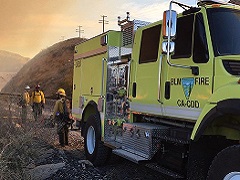 Image of BLM fire fighters standing next to BLM fire truck. Photo by Paul Gibbs/BLM.