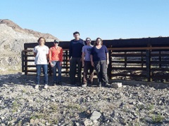 Image of volunteers and BLM staff standing in front of a protected mine. BLM Photo.
