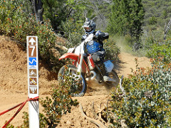 Image of off-road motorcycle on a brush lined path. Photo  by Eric Coulter/BLM 