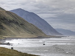 Image of tall grassy hills next to a Pacific beach. Photo by Bob Wick/BLM 