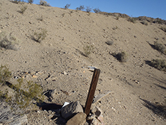 A stake in a the ground marking a mining claim.