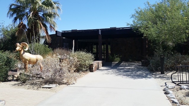 The Santa Rosa and San Jacinto Visitor Center is surrounded by a lush native plant garden. A bighorn sheep statue, "Spikehorn" by Richard Myers, is visible in the foreground. Photo by Dan Kasang, BLM.