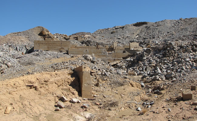 An abandoned mine structure sits on a rocky hillside.  Photo by Peter Graves/BLM.