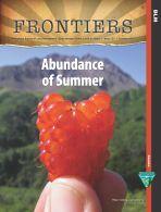 Cover of Frontiers issue 123 "Abundance of Summer" featuring a hiker holding up a salmon berry