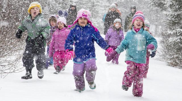 Excited children run through the snow down the trail during a program at the Campbell Creek Science Center.