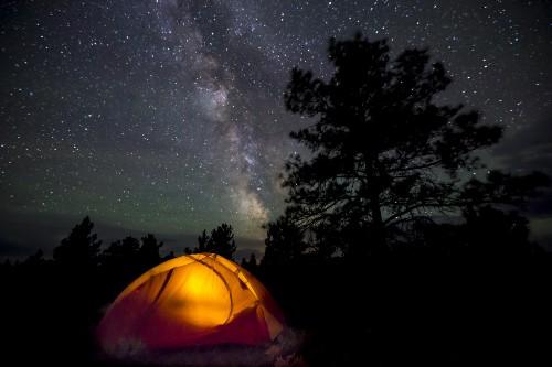 Tent illuminated against starry nightsky