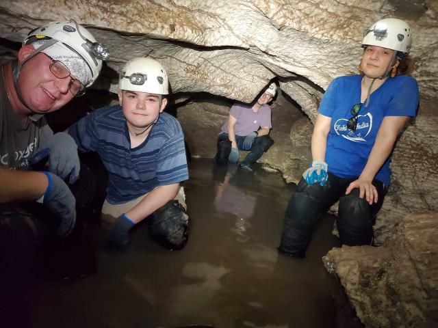 Carlsbad Field Office Staff cool off in the gypsum passages of Parks Ranch Cave.