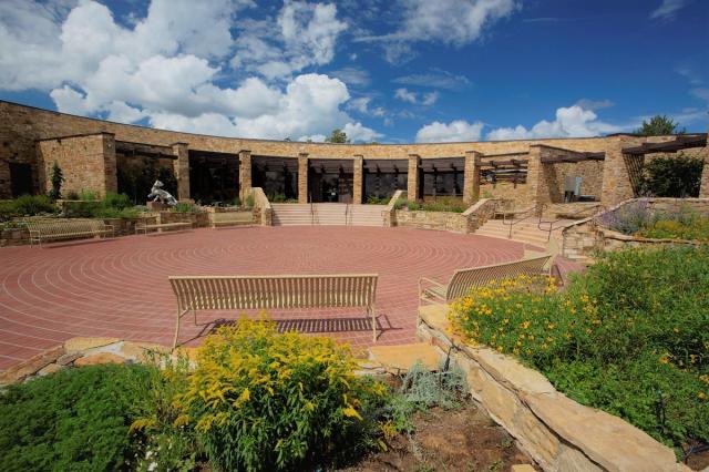 a building and courtyard, the Anazazi Heritage Center in Colorado