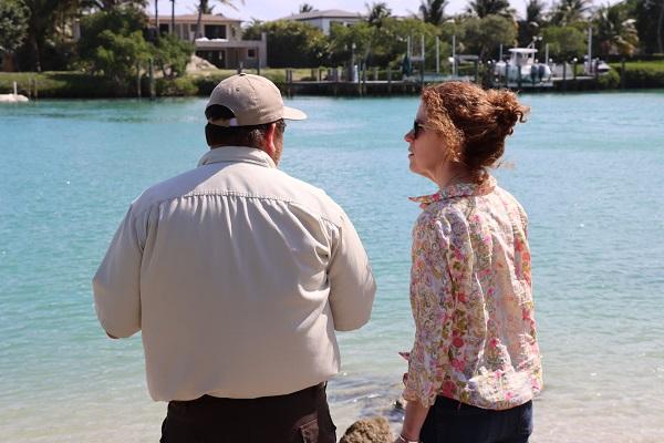 Peter DeWitt and BLM Director Tracy Stone-Manning with their backs facing the camera and looking at the Indian River. 