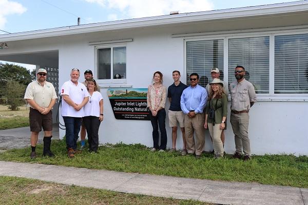BLM staff and the Director standing outside the Jupiter Inlet Lighthouse Outstanding Natural Area field office.