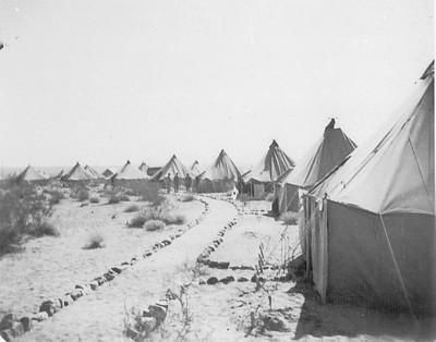 Historical image of army tents in the desert.