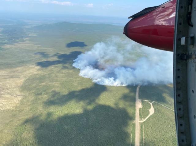 Aerial view of Fish Fire shows smoke crossing the Dalton Highway near the Arctic Circle wayside.