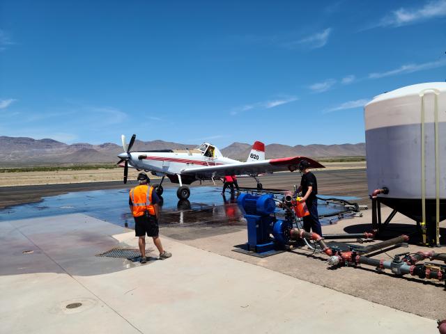 Single engine airtanker on the ground at the Safford Air Ops Center loading with water for a practice drop