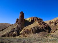 A large pillar of stone sticking out of the earth in Leslie Gulch.