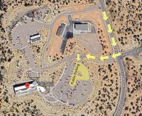 A satellite view of a map, with yellow arrows directing visitors to a new parking location.