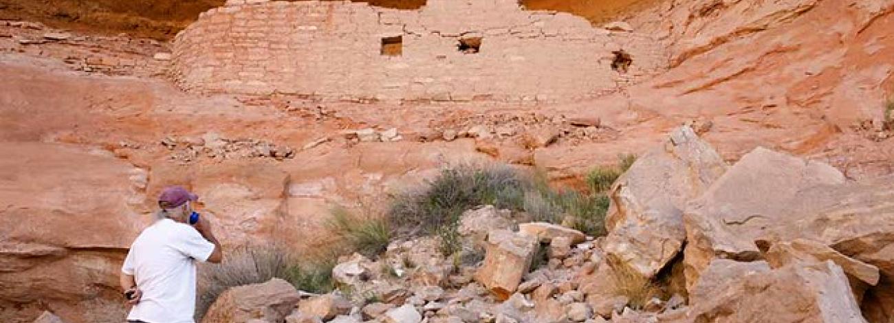 visitor standing in ruins at canyons of the ancients