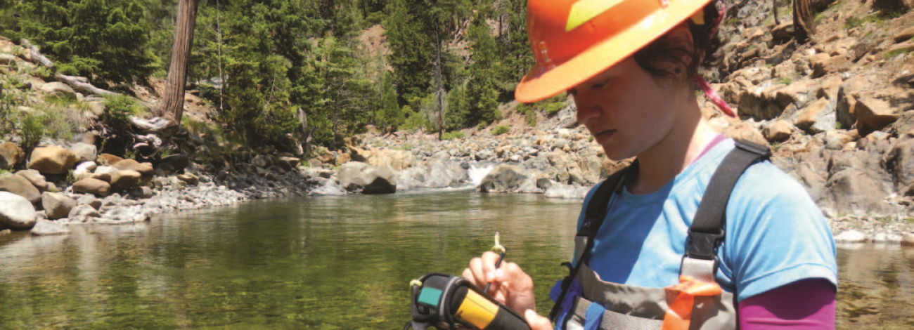 scientist taking measurements in a body of water