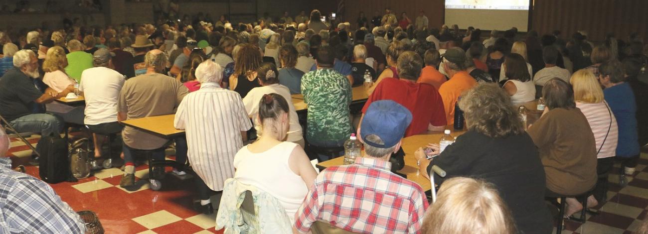 large group of people viewing a presentation