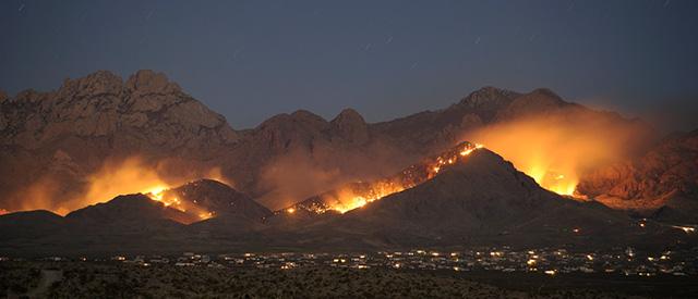 A wildland fire burns on the hillsides near the city of Las Cruces, New Mexico