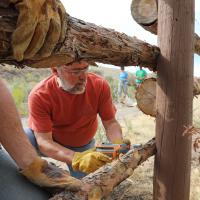 Volunteer builds a wood fence