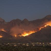 A wildland fire burns on the hillsides near the city of Las Cruces, New Mexico