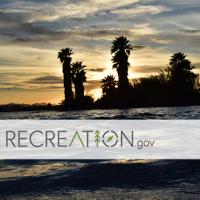 sunset at a lake shore with recreation.gov logo