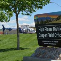The High Plains District sign with a Wyoming air rescue helicopter parked in the background.