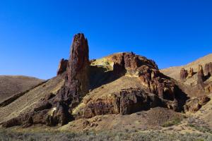 A large pillar of stone sticking out of the earth in Leslie Gulch.