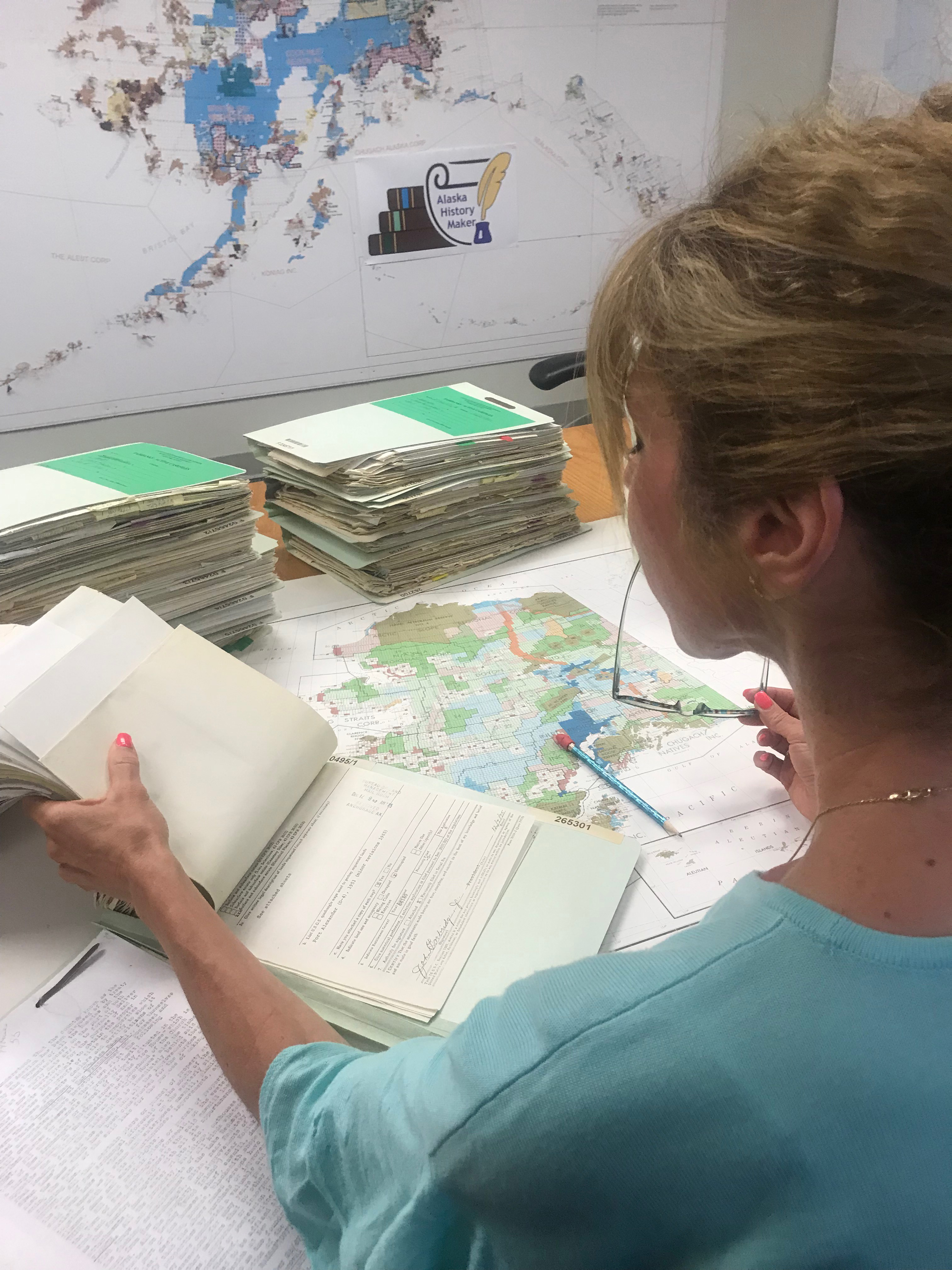 Land Law examiner looking over case files in Alaska