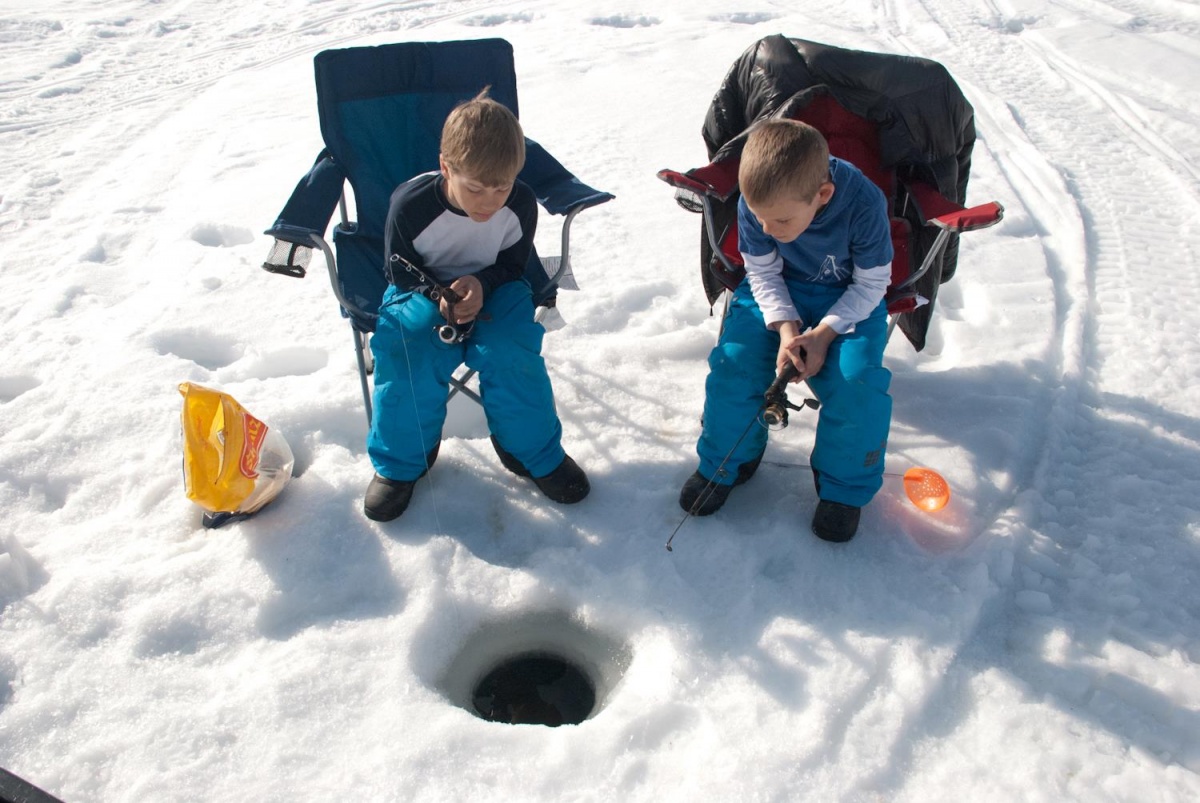 Two boys ice fishing at Silver Lake in Alaska