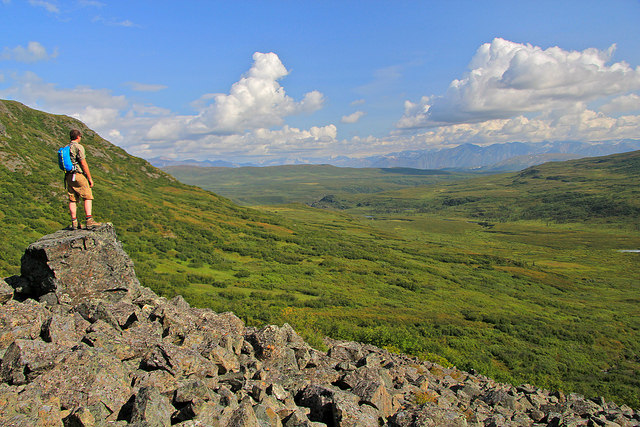 hiker on rock formaton overlooking the Delta Wild and Scenic River