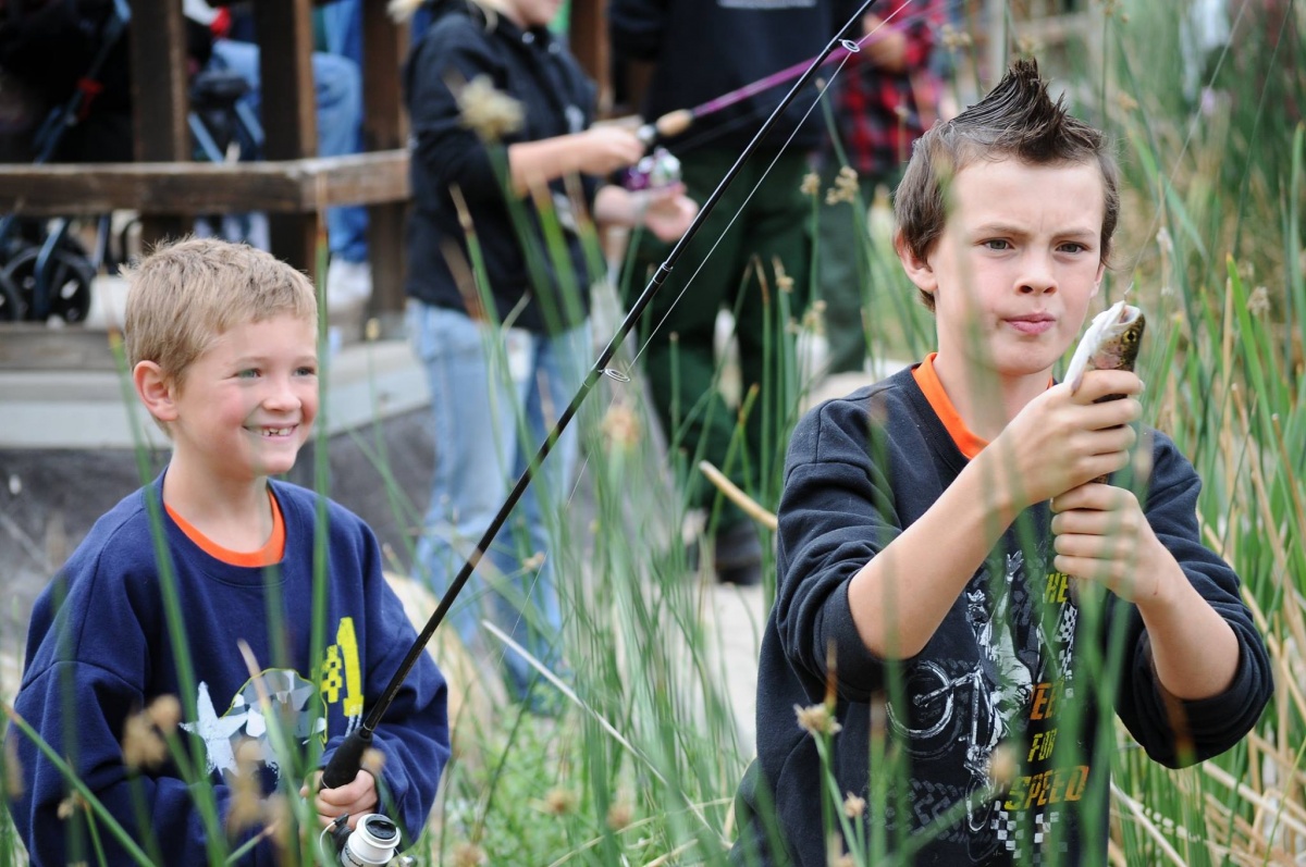 Two young boys enjoy fishing in the Price Field Office area. 
