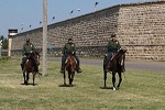 Three Border Patrol agents ride mustangs. BLM photo.
