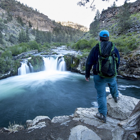 backpacker observing Steelhead Falls on the Deschutes River