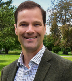 Portrait of Kevin Pendergast with bushes and trees in the background