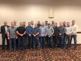 A group photo of the 18 men and women BLM Field Training Officers standing shoulder to shoulder