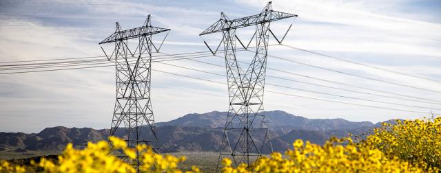 Two transmission towers in a Southwest desert. Photo by BLM.
