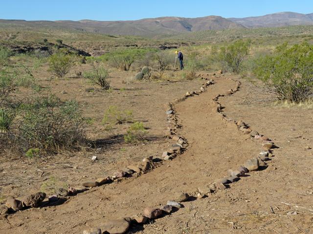 a line of rocks on either side of a trail