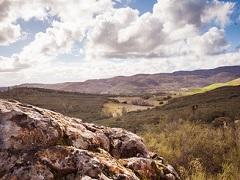 Large clouds over a green valley at Knoxville Management Area. Photo by Jesse Pluim, BLM.