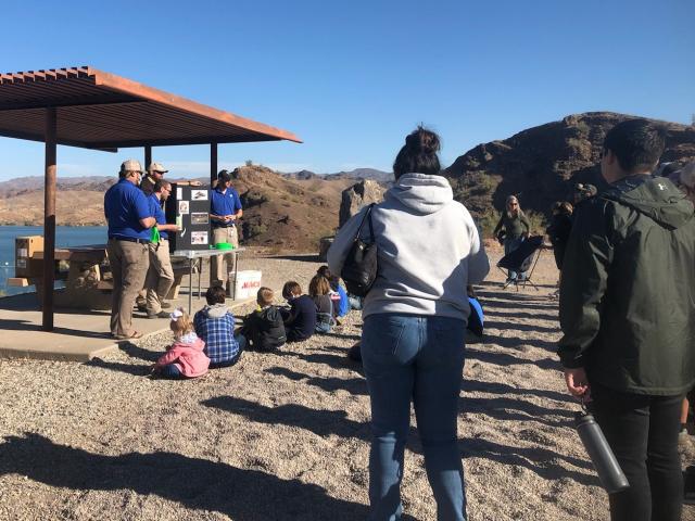 a group of people gathered around a picnic shelter