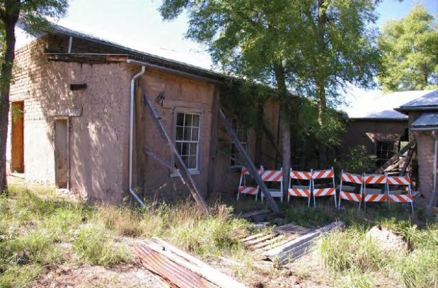 the back of the Fairbank Mercantile building has wood bracing and barricades blocking it off