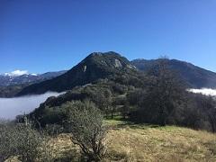 View from atop a mountain overlooking a lake.