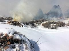 Burn piles on a snowy landscape in northeast California's high desert. Photo by the BLM.
